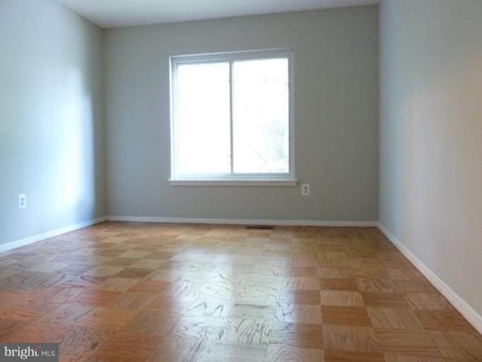 1782 Ivy Oak Square, Unit 79 Reston, VA 20190 - Photo 3 of 23 an empty room with a window
