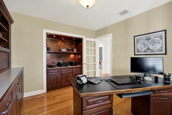 a view of a workspace with furniture and cabinet
