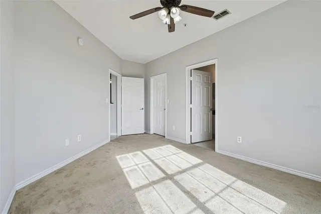 a bathroom with a granite countertop sink toilet mirror and a shower