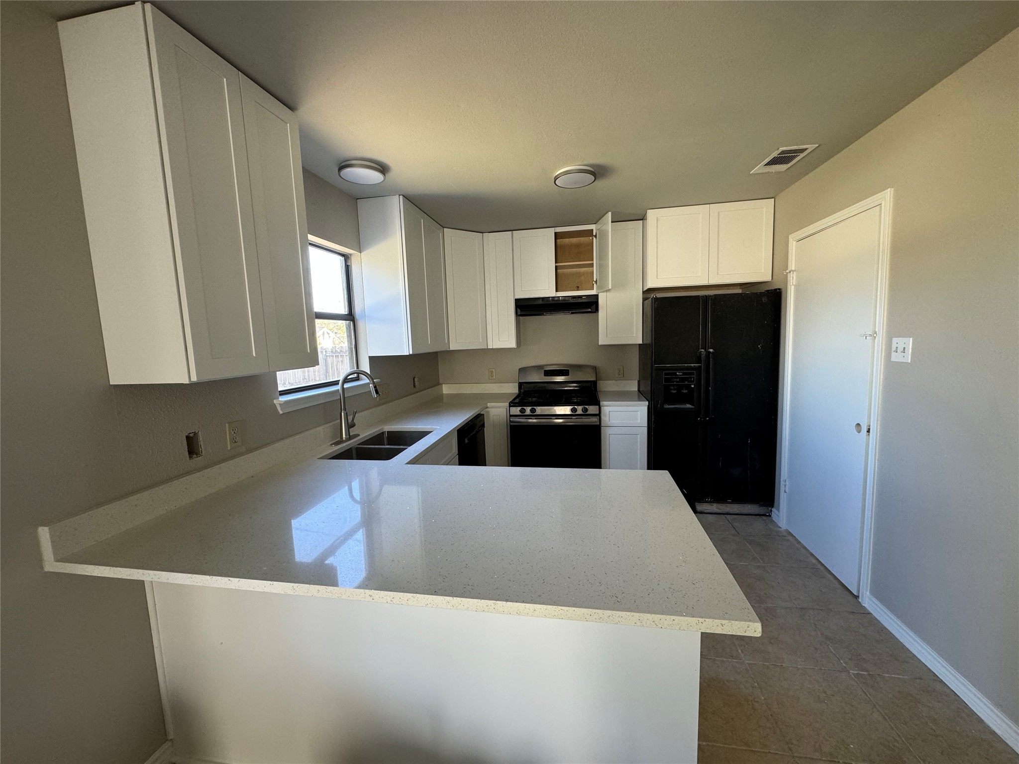 1106 York Castle Drive Pflugerville, TX 78660 - Photo 1 of 1 a kitchen with a refrigerator a stove a sink a counter top space and cabinets