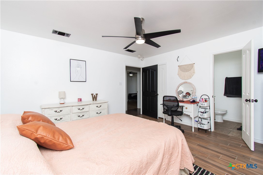 519 Pleasant View Road Troy, TX 76579 - Photo 21 of 30 a bedroom with a bed and a flat screen tv