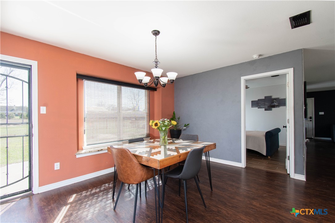 519 Pleasant View Road Troy, TX 76579 - Photo 9 of 30 a dining room with furniture a chandelier and wooden floor