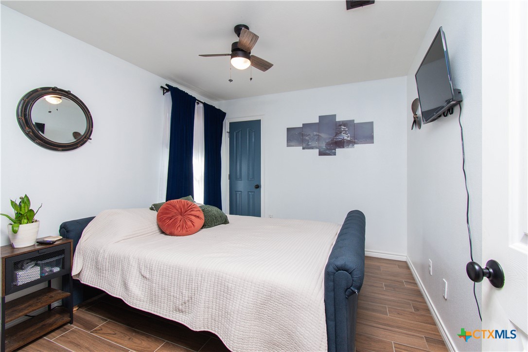 519 Pleasant View Road Troy, TX 76579 - Photo 10 of 30 a bedroom with a bed and a chandelier