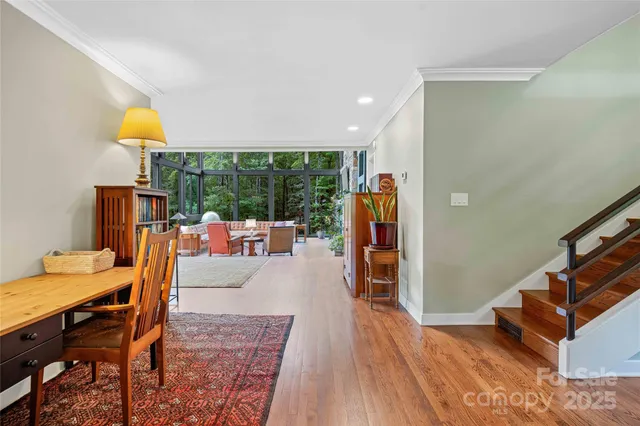 a living room with furniture a rug and a large window