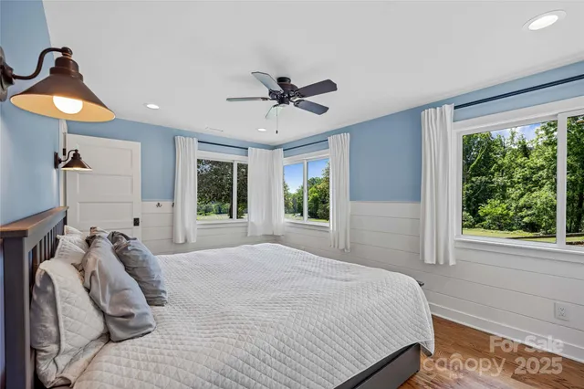 a bedroom with a bed and a large window