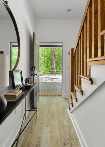a dining room with furniture a chandelier and wooden floor