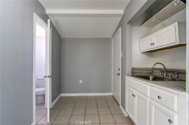 a kitchen with granite countertop a sink and cabinets