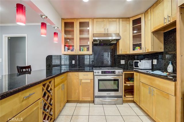 a kitchen with stainless steel appliances granite countertop a stove and a sink