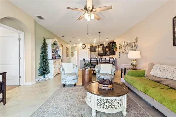 a living room with furniture and a chandelier