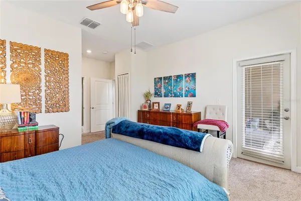 a bedroom with furniture and a large window