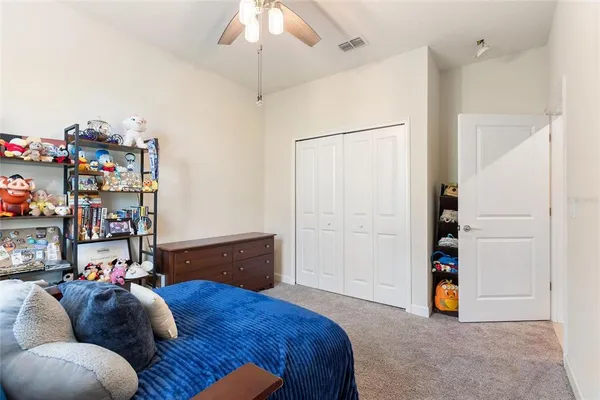 a bedroom with bed and a chandelier