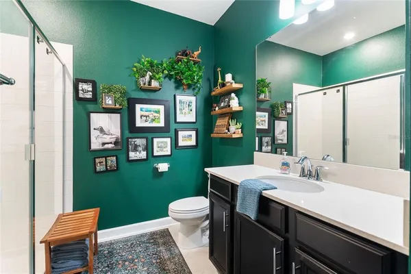 a bathroom with a sink toilet and a mirror