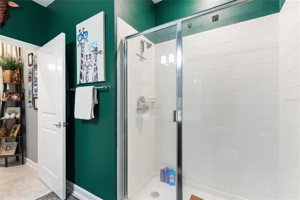 a bathroom with a shower and a sink