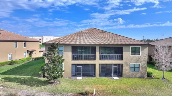 a front view of a house with a garden and yard