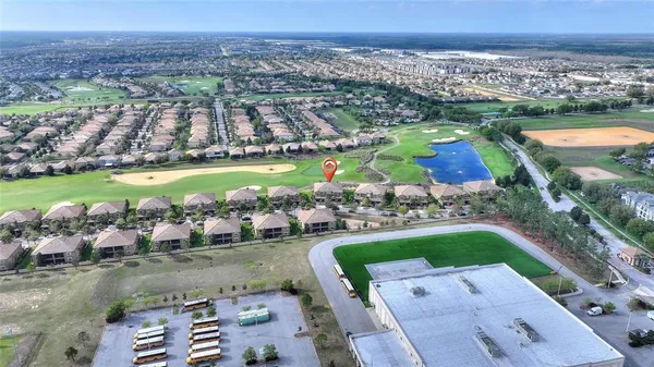 an aerial view of a house with a garden and lake view