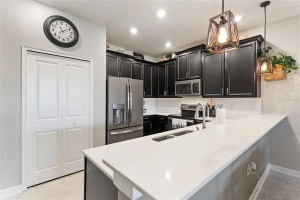 a kitchen with stainless steel appliances a refrigerator and a sink