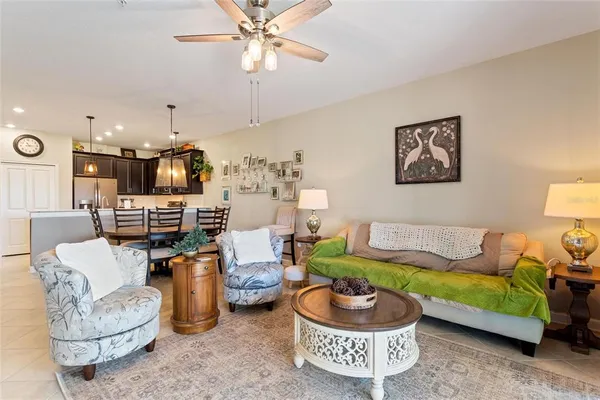 a living room with furniture and a kitchen