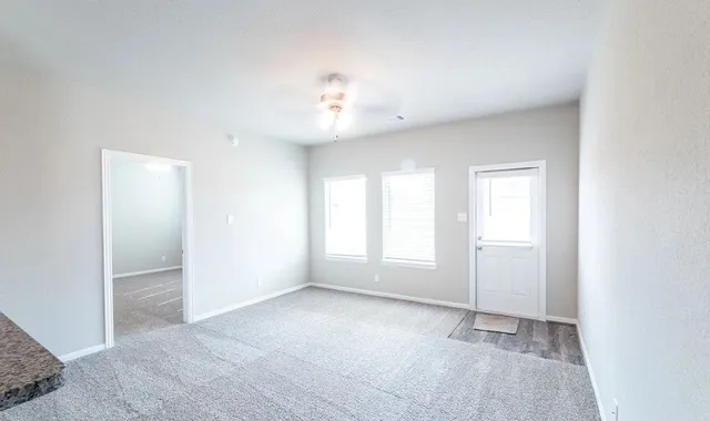 an empty room with windows and closet