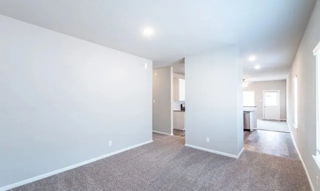 a view of a hallway with bathroom