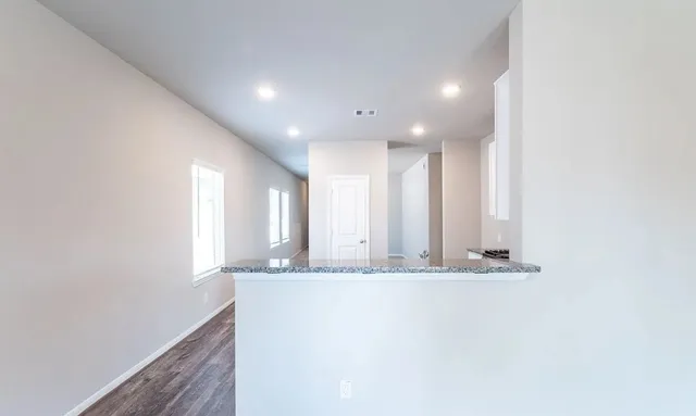 a view of a hallway with granite countertop