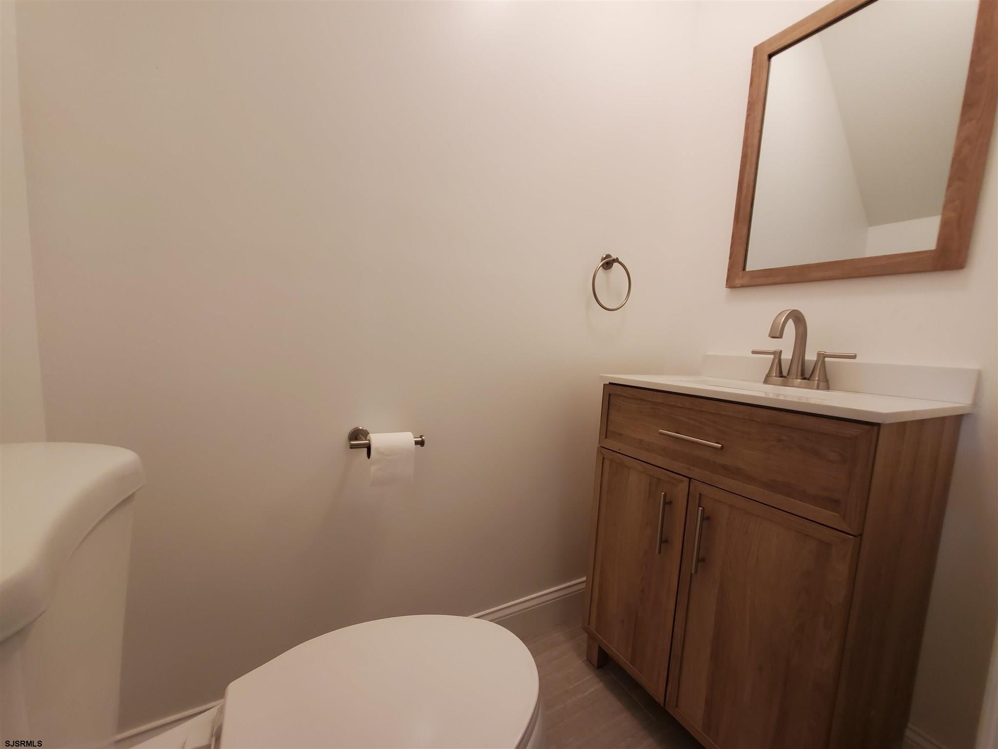 1 North Meadow Ridge Lane Woodbine, NJ 08270 - Photo 11 of 12 a bathroom with a toilet a sink and mirror