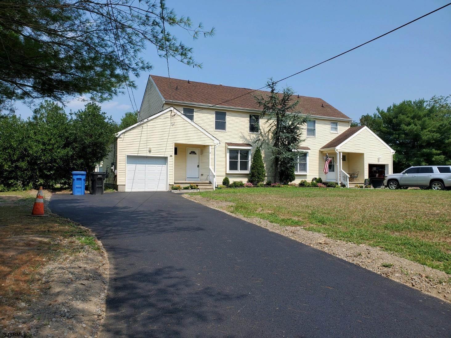 1 North Meadow Ridge Lane Woodbine, NJ 08270 - Photo 2 of 12 a front view of house with yard and green space
