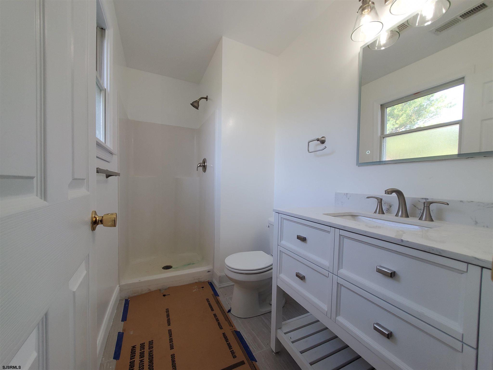 1 North Meadow Ridge Lane Woodbine, NJ 08270 - Photo 9 of 12 a view of bathroom with a toilet sink and mirror
