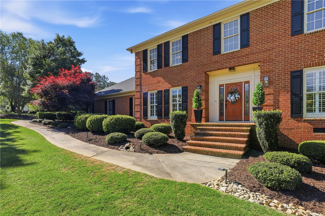 103 5 Knoll Court Anderson, SC 29621 - Photo 2 of 33 A classic brick facade welcomes with well-maintained landscaping and a warm entry.