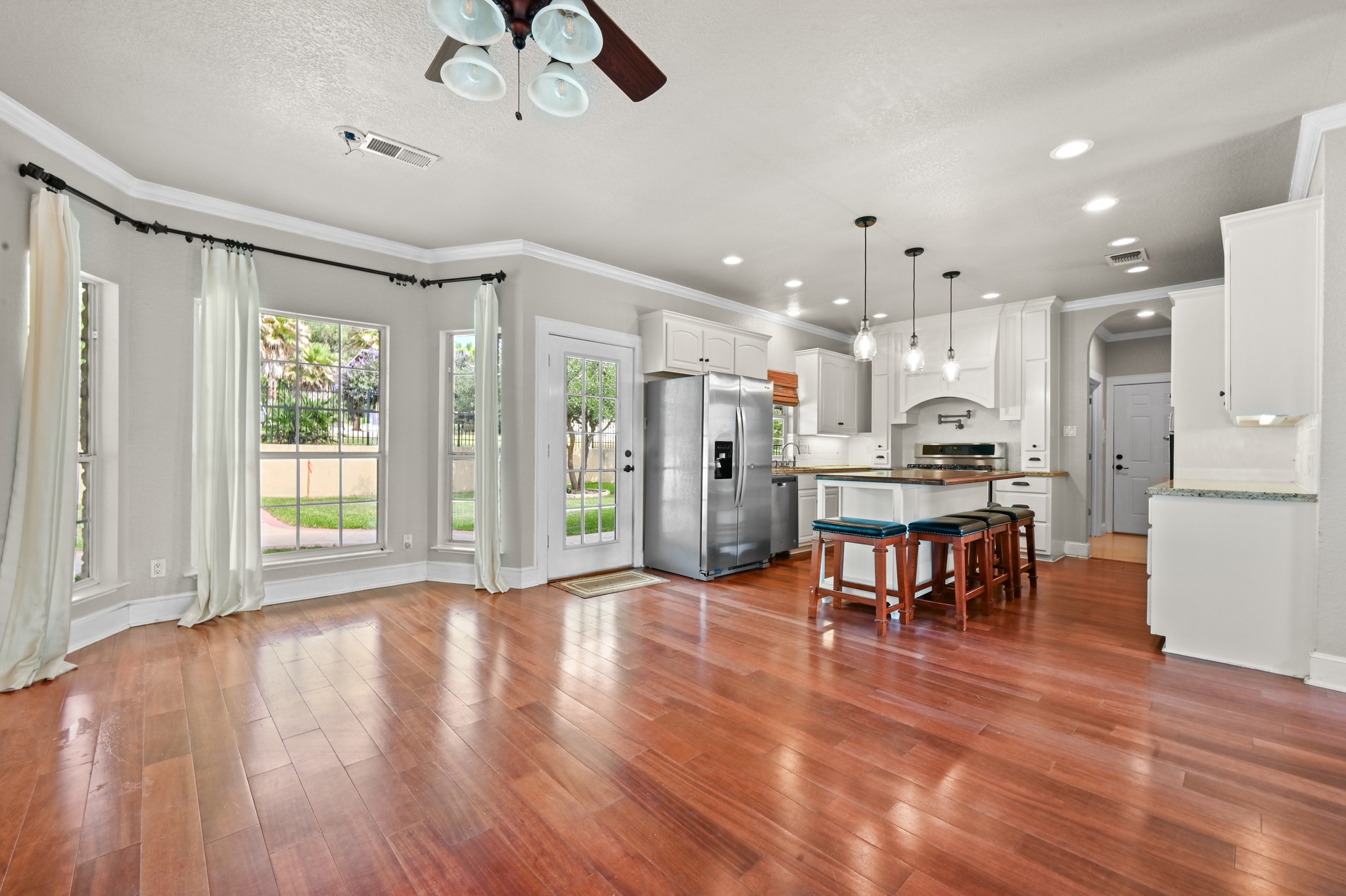 1175 Southern Way Luling, TX 78648 - Photo 20 of 40 Rich hardwood floors unite an open-concept living space with a pristine, well-appointed kitchen.