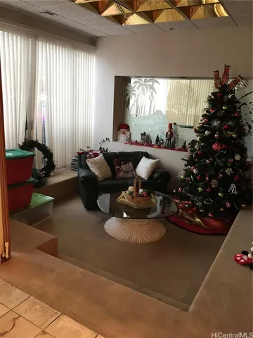 a dining room with furniture and a potted plant