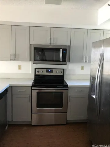 a kitchen with a stove microwave and refrigerator