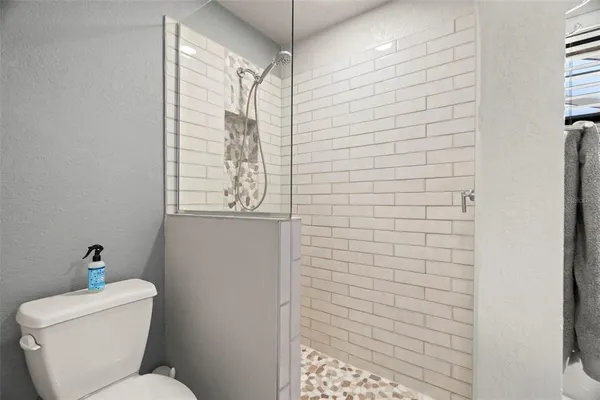 a bathroom with a toilet and a shower