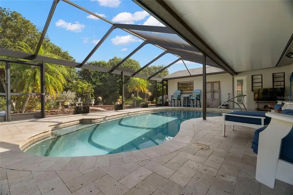 a view of a patio with swimming pool table and chairs