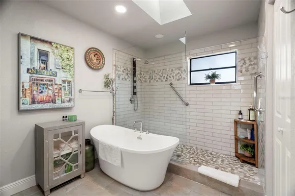 a bathroom with a bathtub and a window