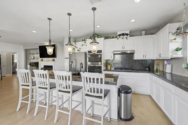 a living room with fireplace furniture and a flat screen tv