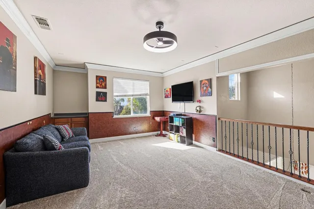 a view of a park with a slide and large trees