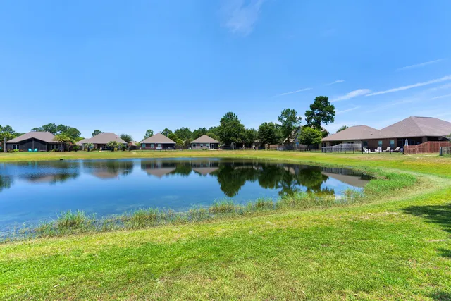 a view of a lake with houses in the background