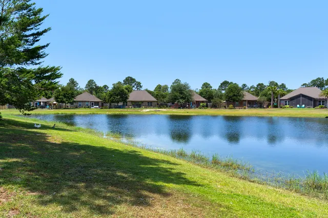 a view of a lake with houses in the back