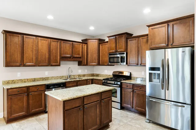 a kitchen with a sink appliances and cabinets