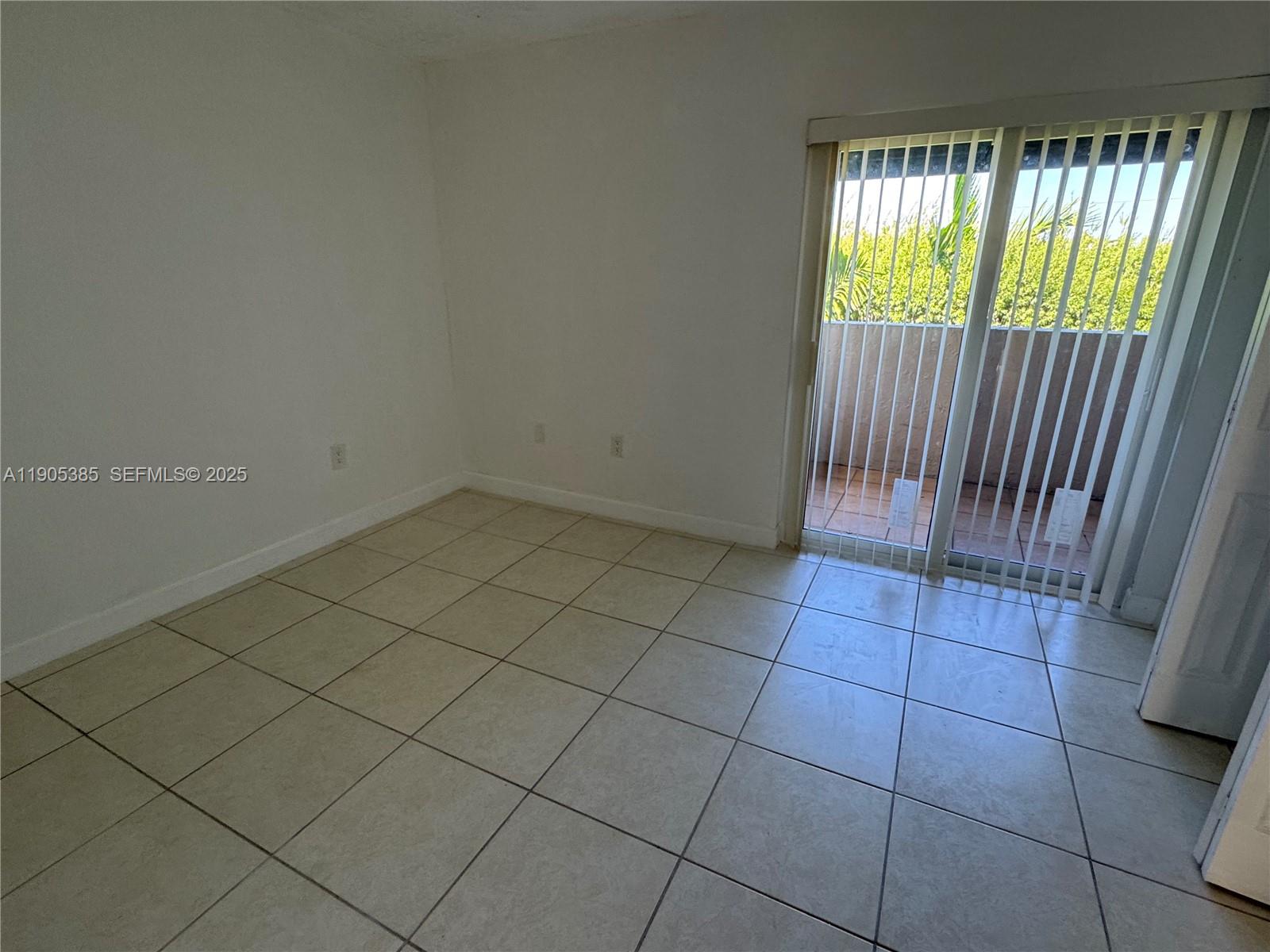 8585 Northwest 6th Lane, Unit 9208 Miami, FL 33126 - Photo 13 of 22 an empty room with windows