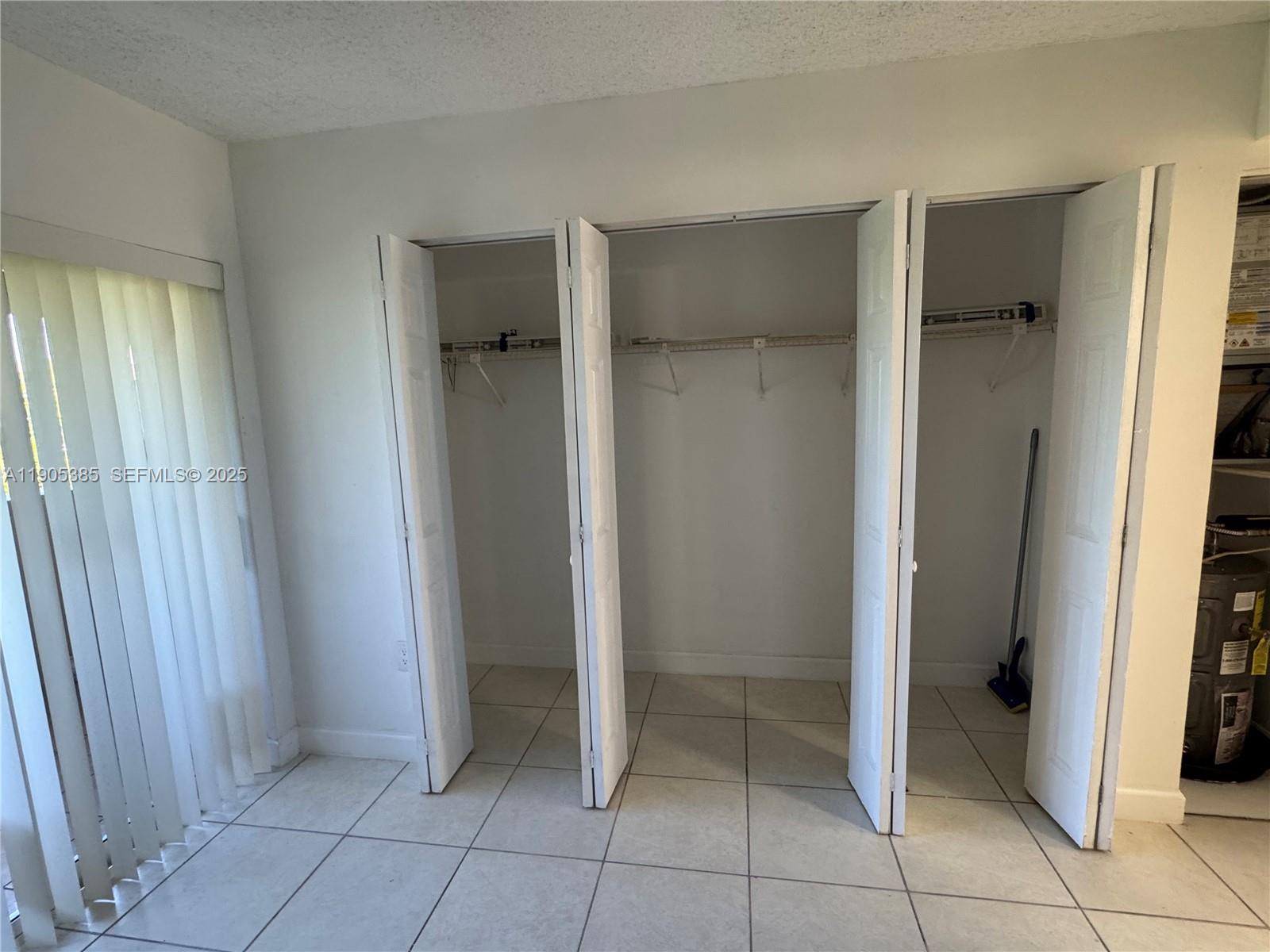 8585 Northwest 6th Lane, Unit 9208 Miami, FL 33126 - Photo 14 of 22 a view of an empty room with closet and a window