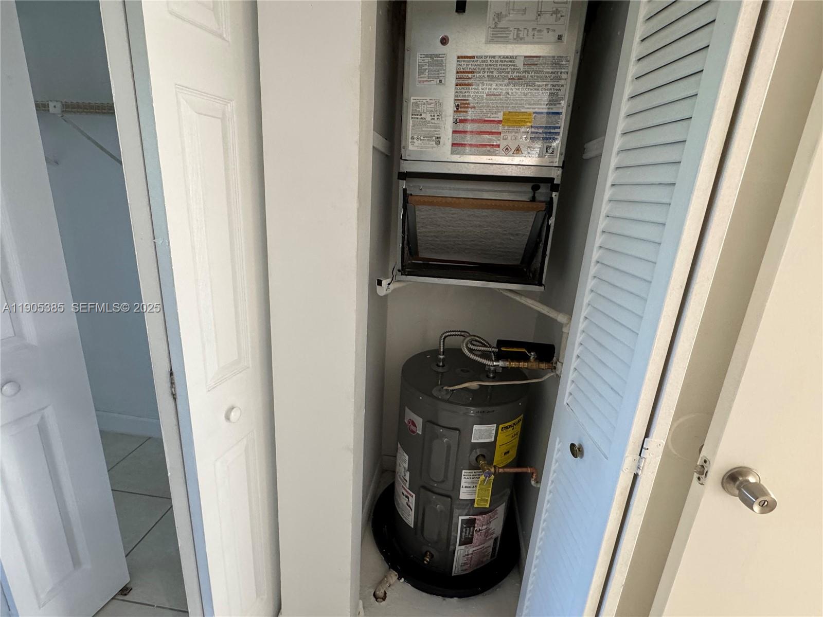 8585 Northwest 6th Lane, Unit 9208 Miami, FL 33126 - Photo 18 of 22 a picture of water heater on a door