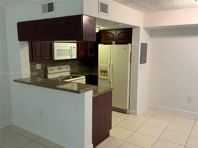 a kitchen with stainless steel appliances a refrigerator and a microwave