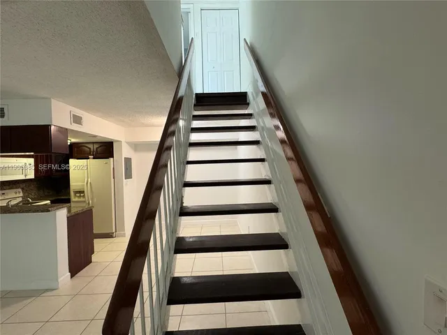 a bathroom with a granite countertop shower and a toilet