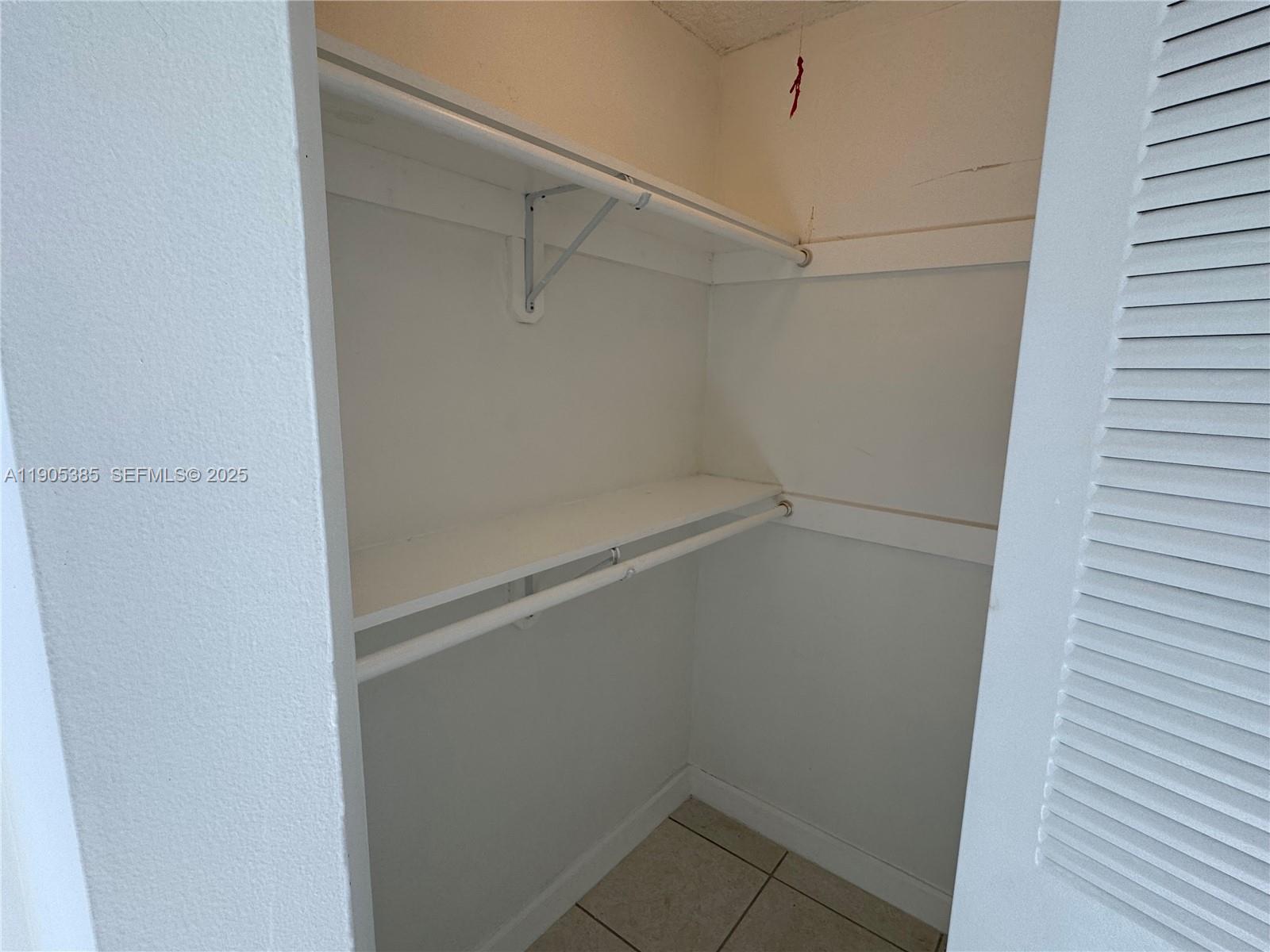 8585 Northwest 6th Lane, Unit 9208 Miami, FL 33126 - Photo 10 of 22 a view of a room with racks on the wall