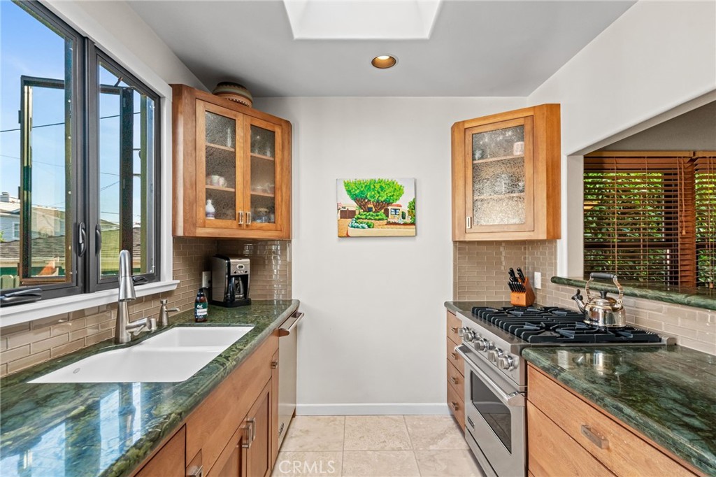 147 Trafalgar Lane San Clemente, CA 92672 - Photo 13 of 37 a kitchen with granite countertop a sink and a stove