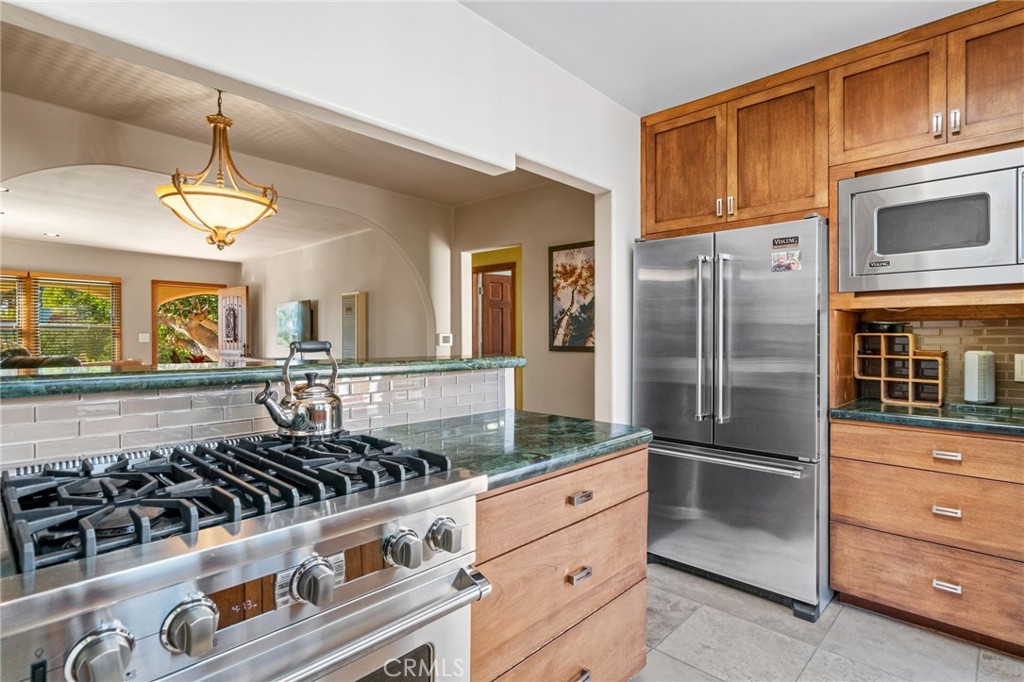 147 Trafalgar Lane San Clemente, CA 92672 - Photo 14 of 37 a kitchen with stainless steel appliances granite countertop a refrigerator and a stove