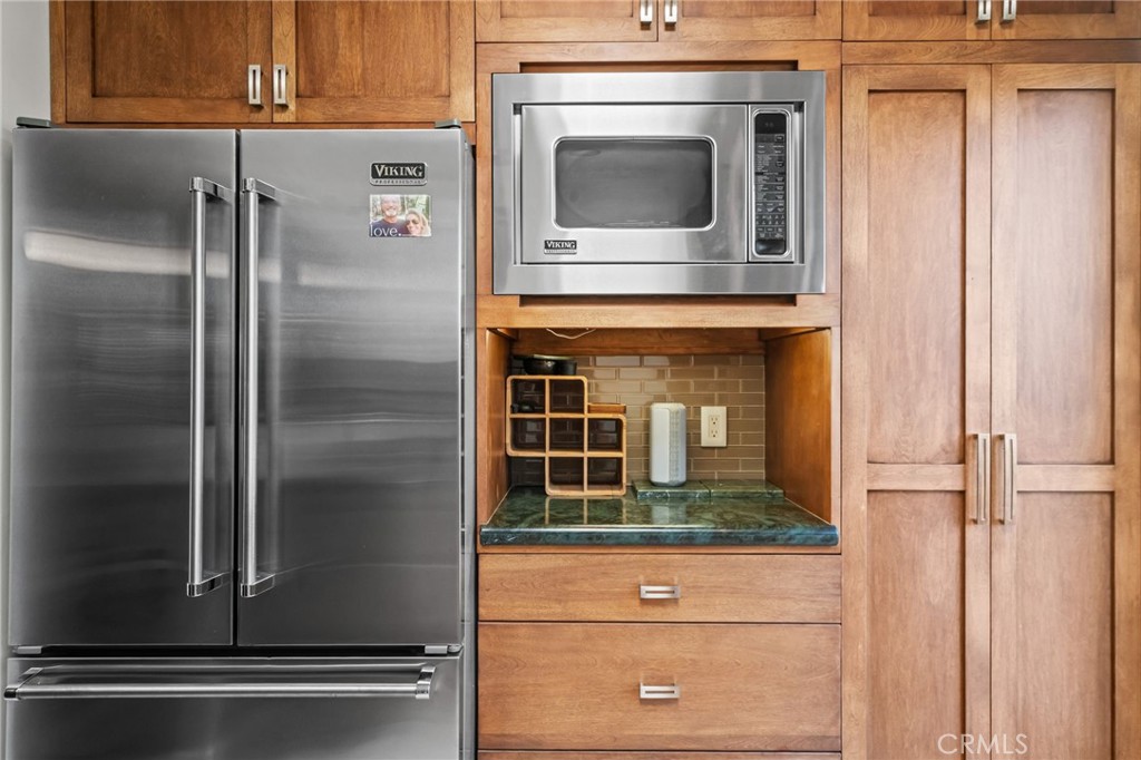 147 Trafalgar Lane San Clemente, CA 92672 - Photo 15 of 37 a kitchen with a refrigerator and stove