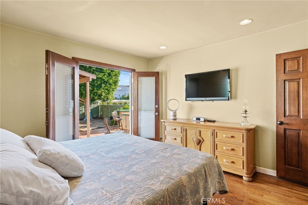 147 Trafalgar Lane San Clemente, CA 92672 - Photo 21 of 37 a bedroom with a large bed and a flat screen tv