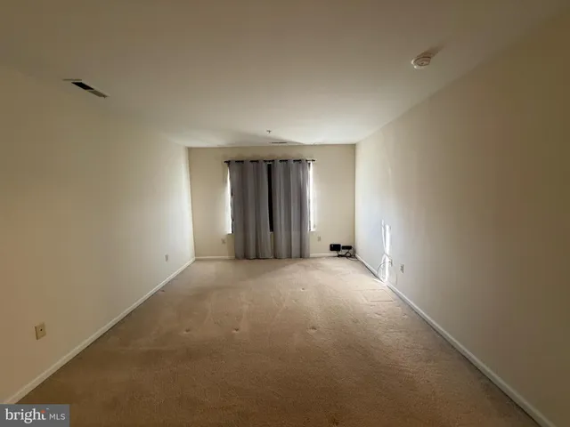 a kitchen with granite countertop a refrigerator and a stove top oven